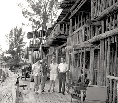 Guests walk along the deck of the Driftwood Inn