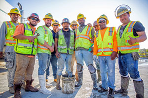 Construction workers are smiling as the bridge nears completion.