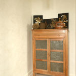 In the hallway to the pantry an antique pie case displays metal and wood renditions of indigenous Mexican ceremonies.