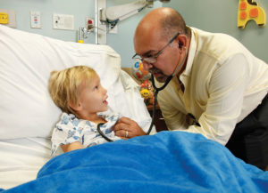 Pediatrician Giraldo Cepeda examines patient Leighton Pressley at Lawnwood Medical Center & Regional Heart Institute
