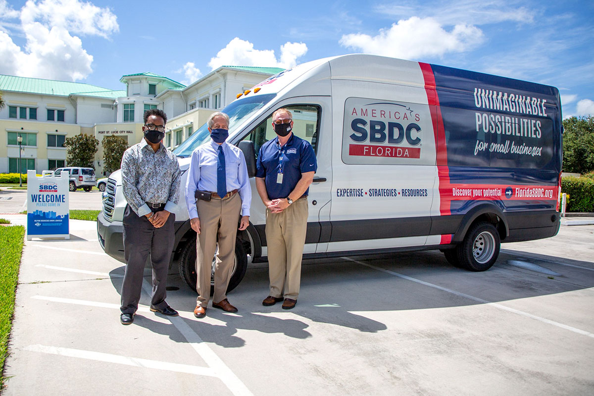 Elijah Wooten, business navigator for the city, City Manager Russ Blackburn and Tom KIndred, regional director of the Florida SBDC at IRSC
